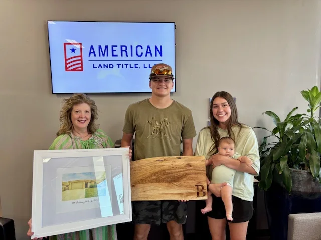A family celebrating a successful home closing with Hilary Wesley