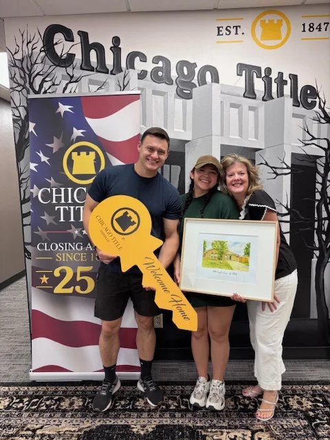 A home buyer celebrating closing day with Hilary Wesley and a keepsake key