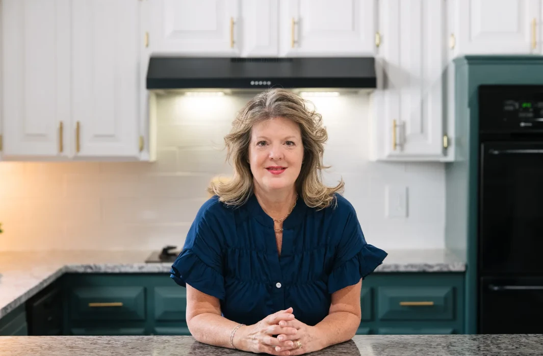 Hilary Wesley, RockOne Realty Broker Associate, seated at a kitchen counter