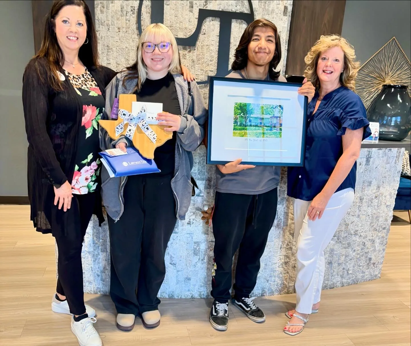 Happy home buyers celebrating their closing with Hilary Wesley and their closing team